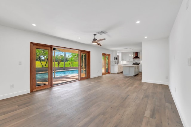 4770 Fox Hunt Trl, Boca Raton, FL 33487 - unfurnished living room with baseboards, ceiling fan, wood finished floors, and recessed lighting