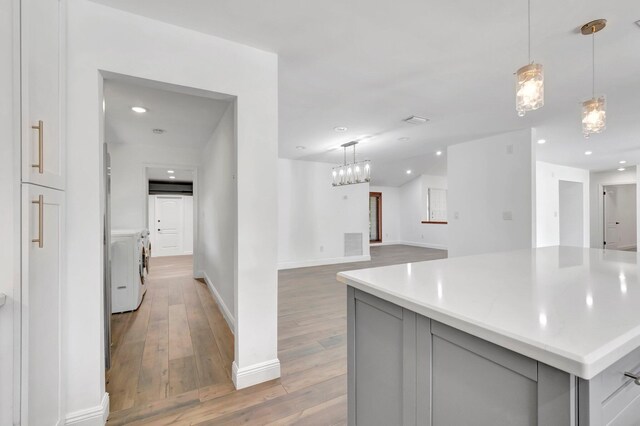4770 Fox Hunt Trl, Boca Raton, FL 33487 - laundry area with washing machine and dryer, light wood-style flooring, recessed lighting, baseboards, and cabinet space