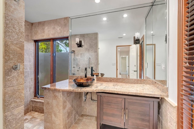 4770 Fox Hunt Trl, Boca Raton, FL 33487 - full bath featuring a sink, a tile shower, recessed lighting, and tile walls