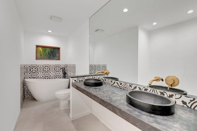 4770 Fox Hunt Trl, Boca Raton, FL 33487 - bathroom featuring a freestanding bath, recessed lighting, a sink, and tile patterned floors