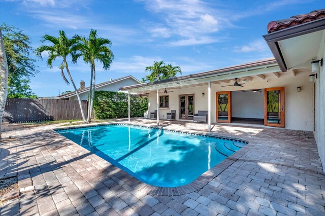 4770 Fox Hunt Trl, Boca Raton, FL 33487 - outdoor pool with french doors, a ceiling fan, and a patio