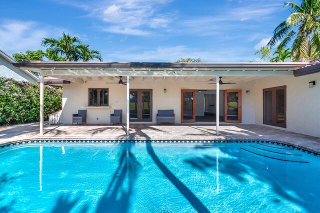 4770 Fox Hunt Trl, Boca Raton, FL 33487 - swimming pool with a ceiling fan, french doors, a patio area, and fence