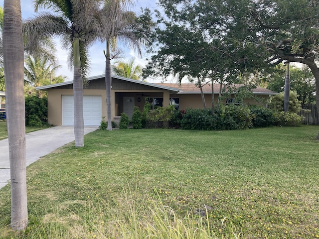 1672 Thumb Point Dr, Fort Pierce, FL 34949 - single story home with an attached garage, driveway, a front yard, and stucco siding