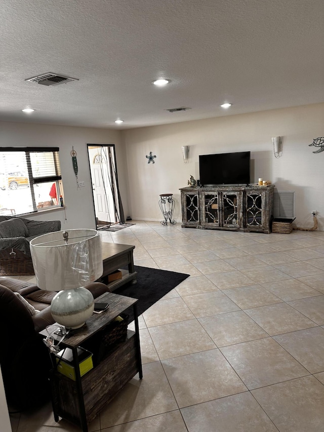 1672 Thumb Point Dr, Fort Pierce, FL 34949 - living room with tile patterned floors, visible vents, a textured ceiling, and recessed lighting