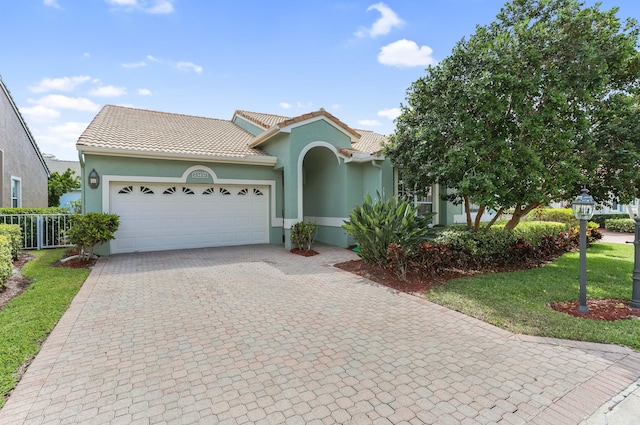 23437 Torre Cir, Boca Raton, FL 33433 - view of front of house featuring stucco siding, an attached garage, decorative driveway, and a tiled roof