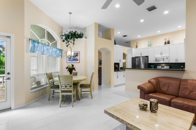 23437 Torre Cir, Boca Raton, FL 33433 - living room featuring arched walkways, a ceiling fan, and recessed lighting