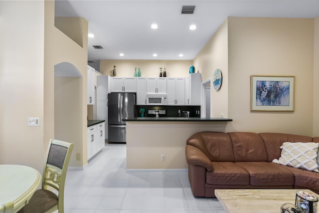 23437 Torre Cir, Boca Raton, FL 33433 - living room with recessed lighting and light tile patterned floors