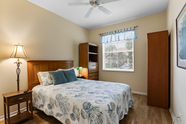 23437 Torre Cir, Boca Raton, FL 33433 - bedroom with wood finished floors, baseboard heating, and a ceiling fan