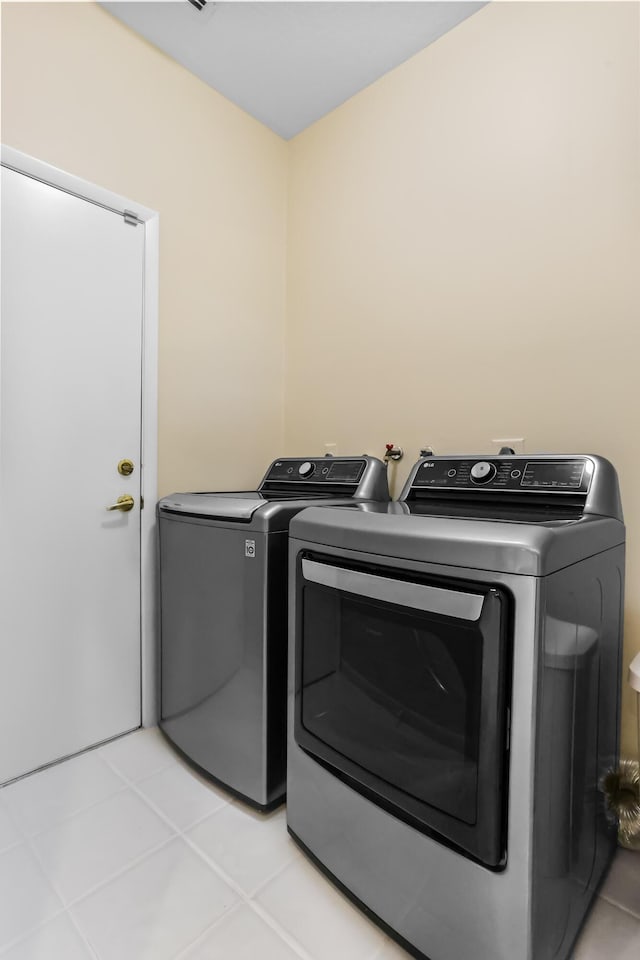 23437 Torre Cir, Boca Raton, FL 33433 - washroom with separate washer and dryer and light tile patterned floors