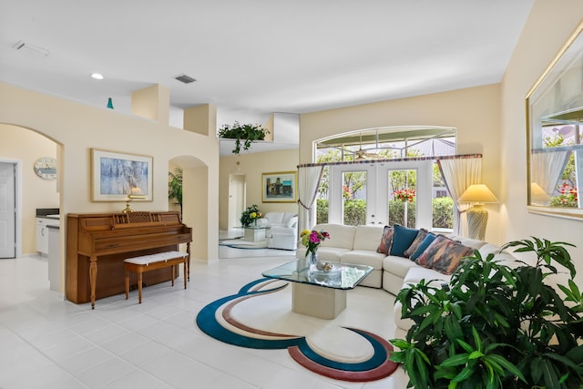 23437 Torre Cir, Boca Raton, FL 33433 - tiled living area with french doors, arched walkways, healthy amount of natural light, and a high ceiling