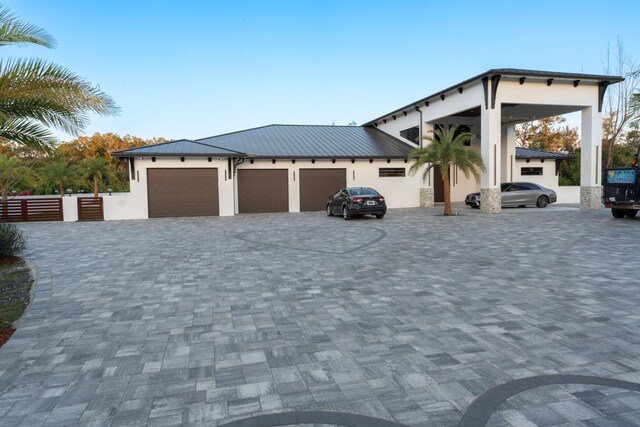 2810 F Rd, Loxahatchee Groves, FL 33470 - view of front facade featuring stucco siding, a metal roof, and a standing seam roof