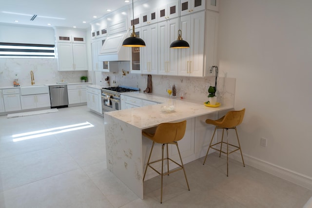 2810 F Rd, Loxahatchee Groves, FL 33470 - kitchen featuring appliances with stainless steel finishes, backsplash, white cabinetry, and a peninsula