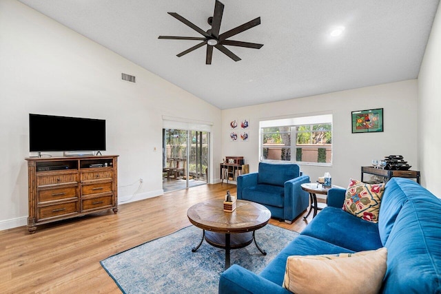 living room with high vaulted ceiling, a ceiling fan, baseboards, light wood-type flooring, and visible vents