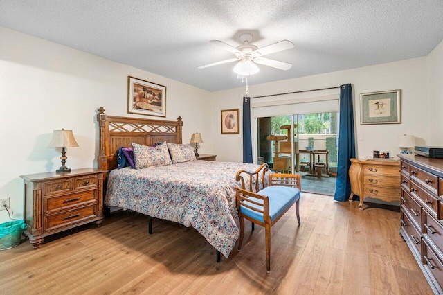 bedroom with access to outside, a textured ceiling, light wood-style floors, and a ceiling fan