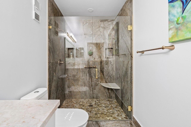 full bathroom featuring a marble finish shower, vanity, toilet, and visible vents
