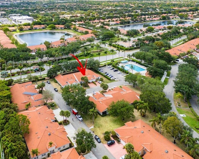 birds eye view of property with a water view and a residential view