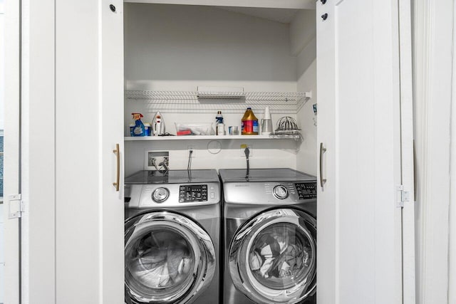 washroom featuring laundry area and washer and dryer