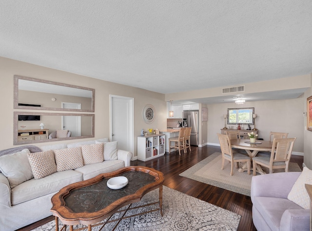336 Golfview Rd Unit 406, North Palm Beach, FL 33408 - living room with a textured ceiling, dark wood-style floors, and baseboards
