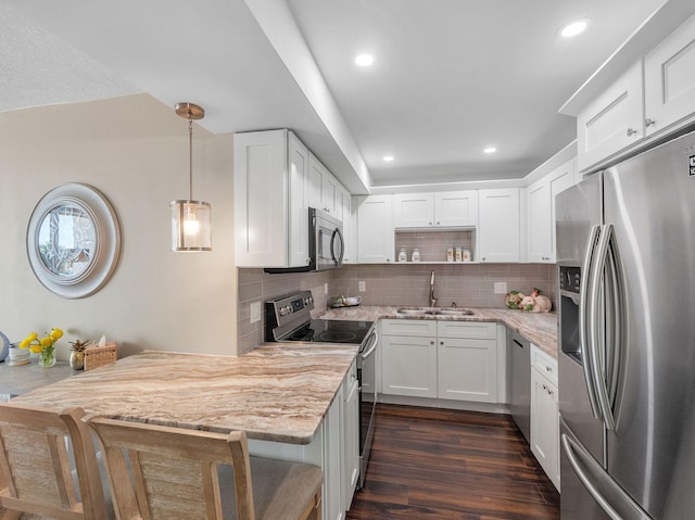 336 Golfview Rd Unit 406, North Palm Beach, FL 33408 - kitchen with appliances with stainless steel finishes, a sink, open shelves, white cabinets, and light stone countertops