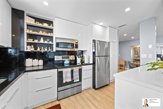 137 Golden Isles Dr Unit 1605, Hallandale Beach, FL 33009 - kitchen with stainless steel appliances, modern cabinets, light wood-type flooring, white cabinets, and recessed lighting