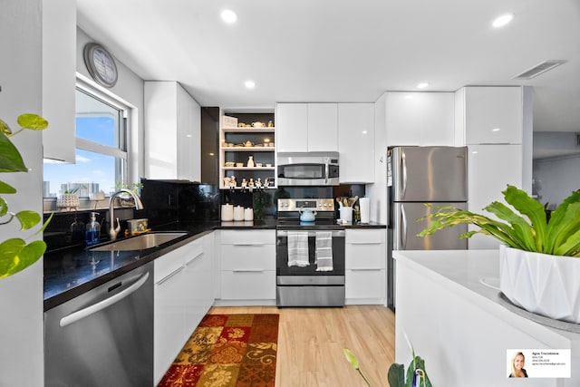 137 Golden Isles Dr Unit 1605, Hallandale Beach, FL 33009 - kitchen with stainless steel appliances, modern cabinets, white cabinets, open shelves, and dark countertops