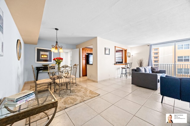 137 Golden Isles Dr Unit 501, Hallandale Beach, FL 33009 - dining area featuring a chandelier, light tile patterned floors, and a textured ceiling