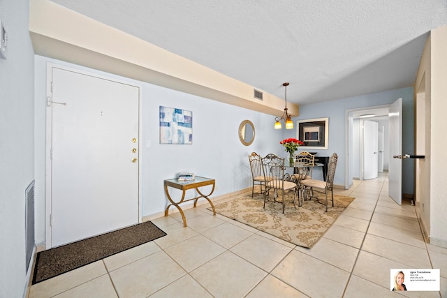 137 Golden Isles Dr Unit 501, Hallandale Beach, FL 33009 - dining room featuring light tile patterned floors and a textured ceiling