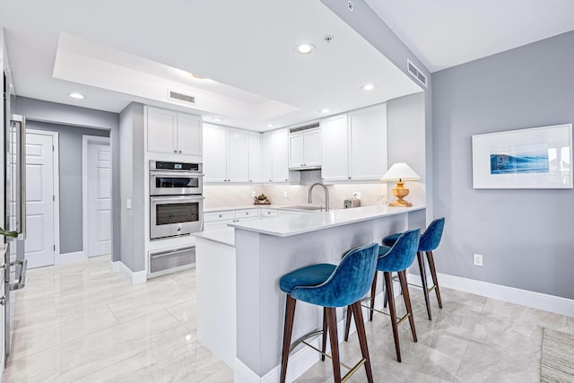 500 S US Highway 1 Unit 201, Jupiter, FL 33477 - kitchen with a sink, double oven, a warming drawer, marble finish floor, and recessed lighting