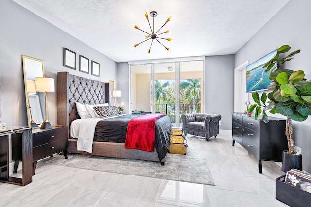 500 S US Highway 1 Unit 201, Jupiter, FL 33477 - bedroom with an inviting chandelier, marble finish floor, a textured ceiling, and access to exterior