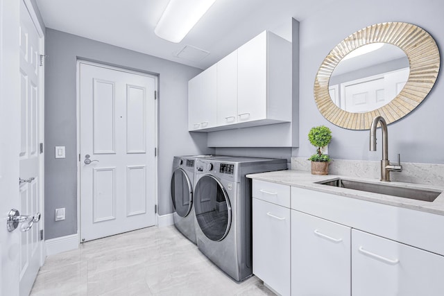 500 S US Highway 1 Unit 201, Jupiter, FL 33477 - washroom featuring a sink, cabinet space, baseboards, visible vents, and independent washer and dryer