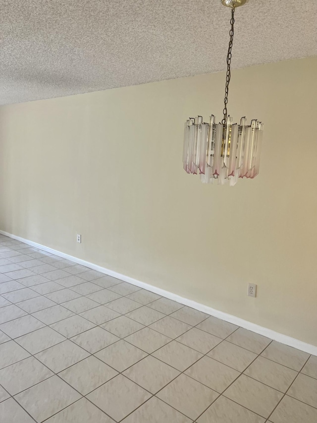 3529 Englewood Dr Unit 313, Lake Worth, FL 33467 - empty room with a chandelier, a textured ceiling, and baseboards