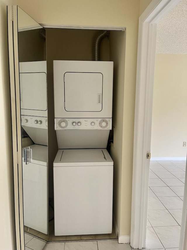 3529 Englewood Dr Unit 313, Lake Worth, FL 33467 - washroom with stacked washing machine and dryer and baseboards