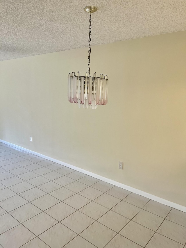 3529 Englewood Dr Unit 313, Lake Worth, FL 33467 - unfurnished room with a chandelier, a textured ceiling, and baseboards