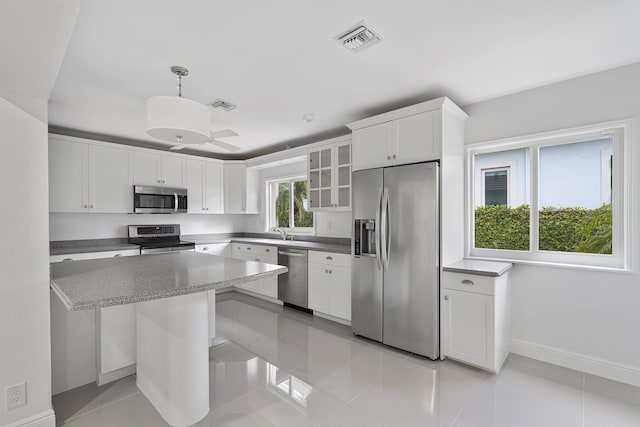 kitchen with light tile patterned floors, visible vents, appliances with stainless steel finishes, and white cabinetry
