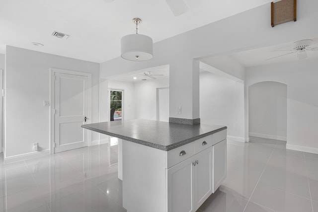 kitchen with ceiling fan, visible vents, baseboards, dark countertops, and white cabinets
