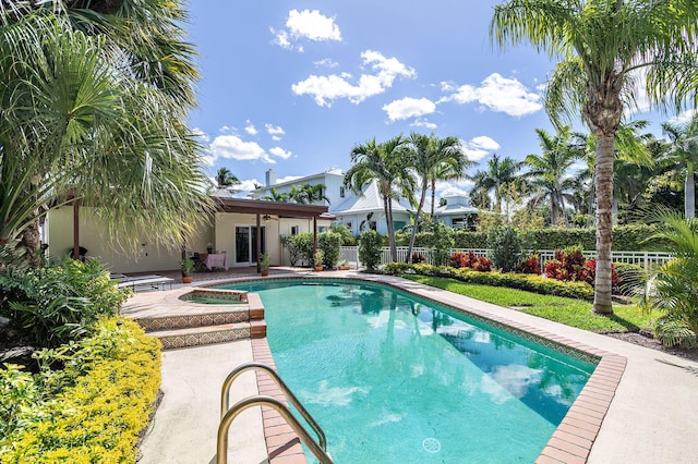 view of pool featuring a patio area, a fenced in pool, ceiling fan, a jacuzzi, and fence