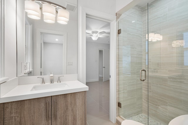 full bath featuring vanity, tile patterned floors, a stall shower, a ceiling fan, and visible vents