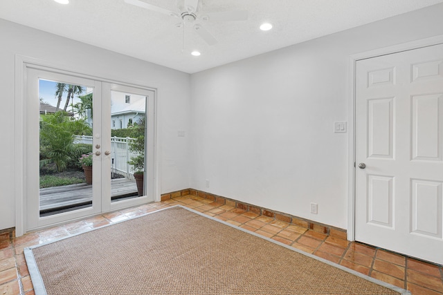 empty room with recessed lighting, tile patterned floors, a ceiling fan, baseboards, and french doors