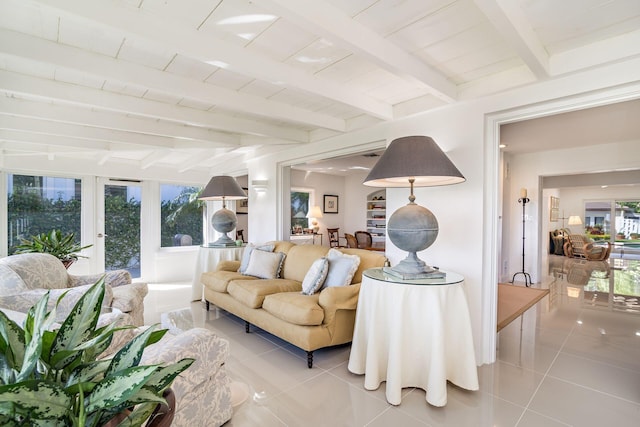 living room featuring beam ceiling and light tile patterned floors