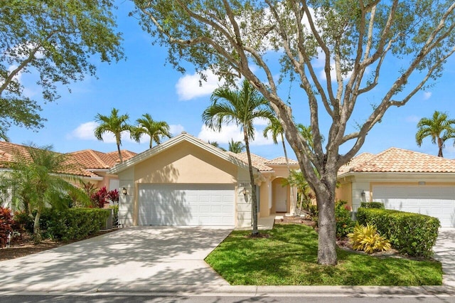 view of front facade with a tiled roof, an attached garage, driveway, and stucco siding