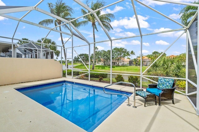 outdoor pool featuring a lanai and a patio area