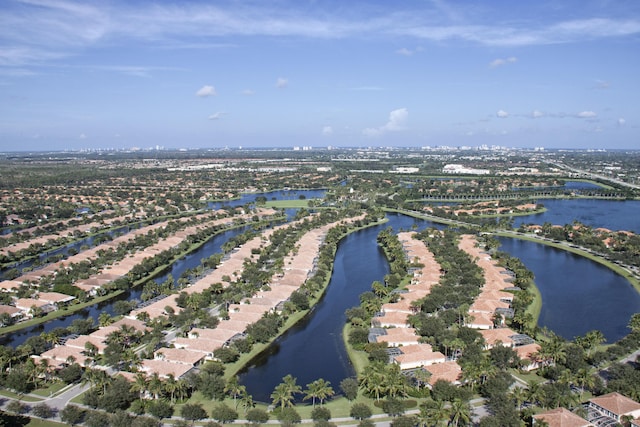 drone / aerial view with a water view and a residential view