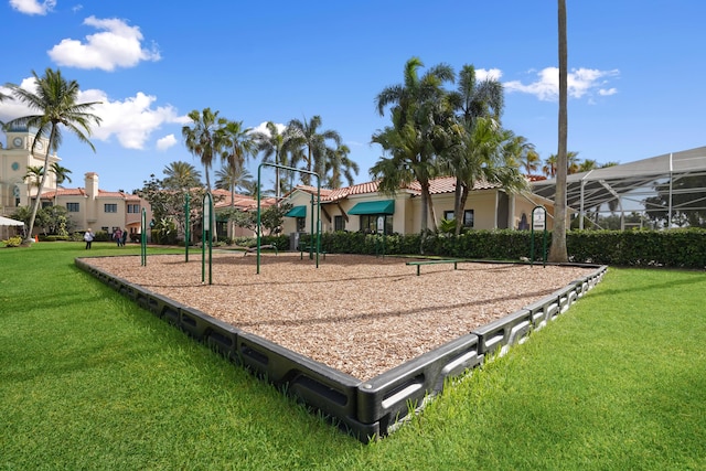 view of property's community featuring playground community and a yard
