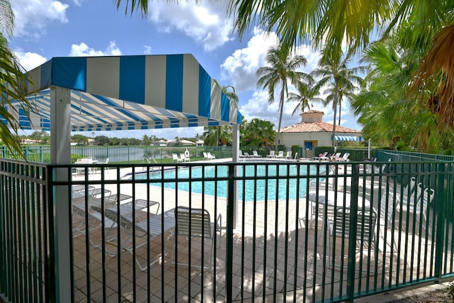 pool with fence and a patio