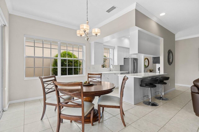 dining space featuring a chandelier, baseboards, light tile patterned floors, visible vents, and ornamental molding