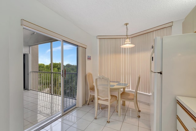 5910 Morningstar Cir Unit 401, Delray Beach, FL 33484 - dining area with a textured ceiling and light tile patterned flooring