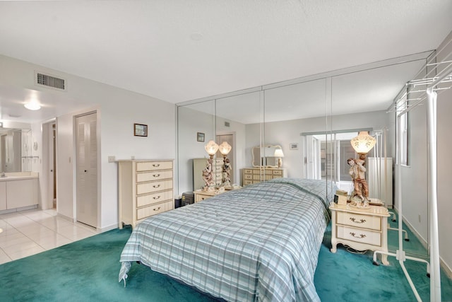 5910 Morningstar Cir Unit 401, Delray Beach, FL 33484 - tiled bedroom featuring baseboards, multiple closets, visible vents, and carpet flooring