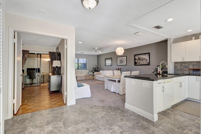 297 Cactus Hill Ct, Royal Palm Beach, FL 33411 - kitchen with stainless steel microwave, white range with electric cooktop, a textured ceiling, white cabinets, and dark countertops