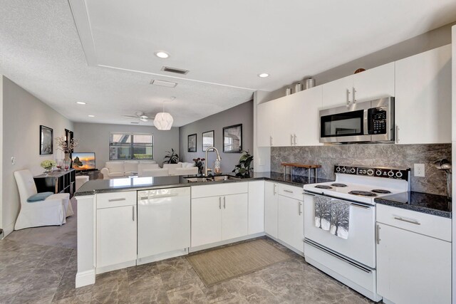 297 Cactus Hill Ct, Royal Palm Beach, FL 33411 - kitchen with appliances with stainless steel finishes, baseboards, backsplash, white cabinets, and recessed lighting