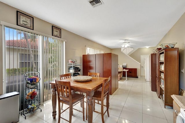 dining room featuring light tile patterned floors, visible vents, and ceiling fan